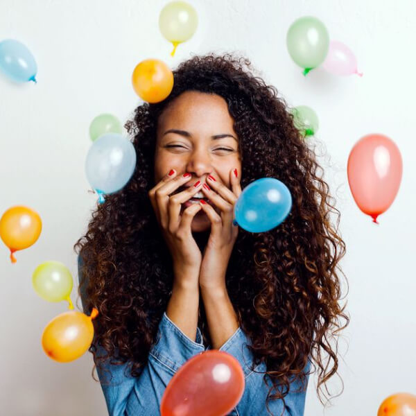Happy teenage girl with balloons