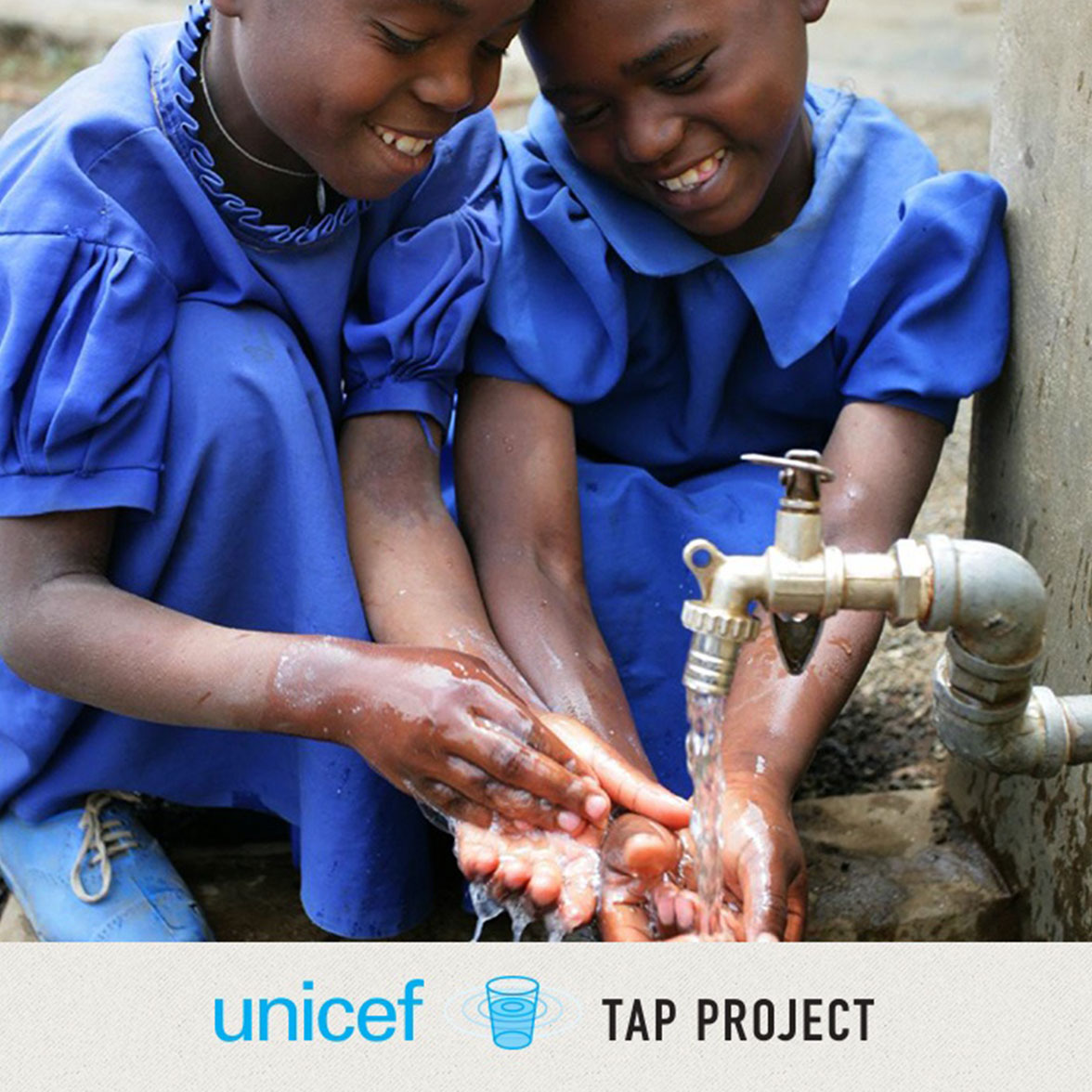 Two young girls washing their hands