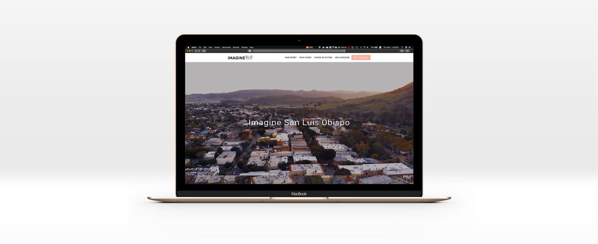 A macbook pro displaying the imagine SLO website