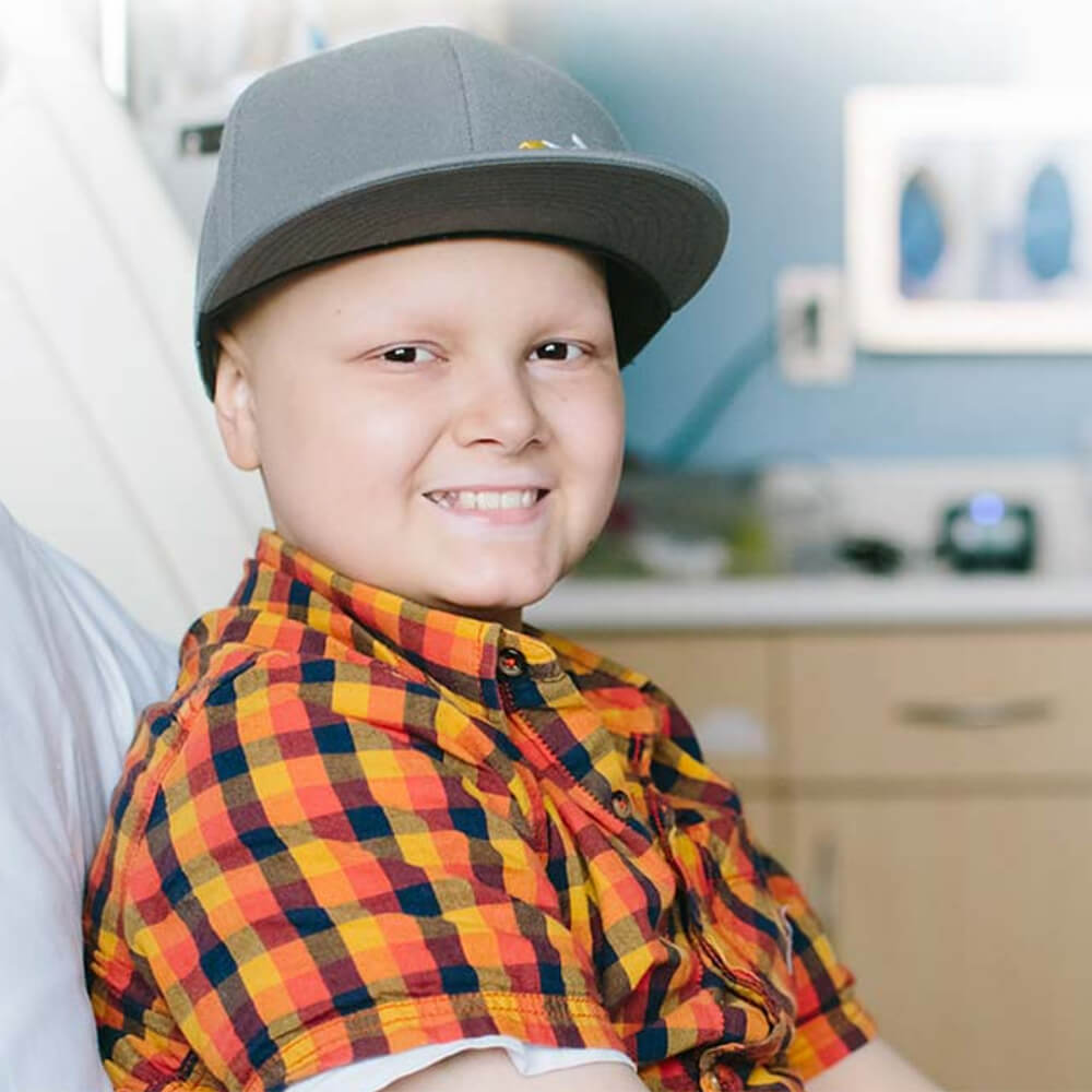 a young boy posing in a hospital bed