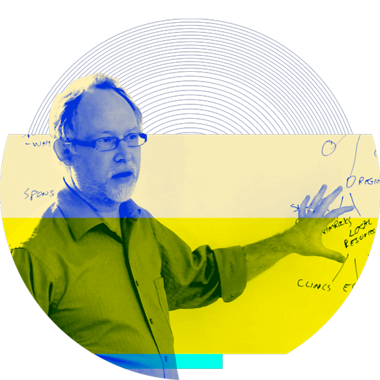 Matchfire's Doug Klein in front of a whiteboard, illustrating data science solutions for a client.