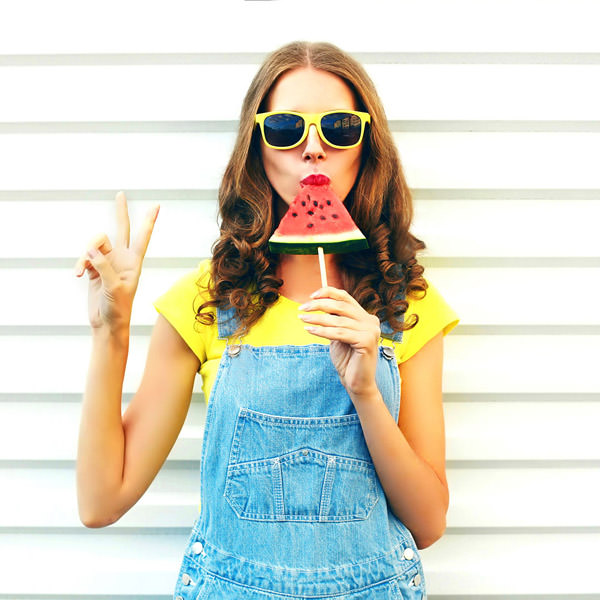 Girl in sunglasses with watermelon during summertime